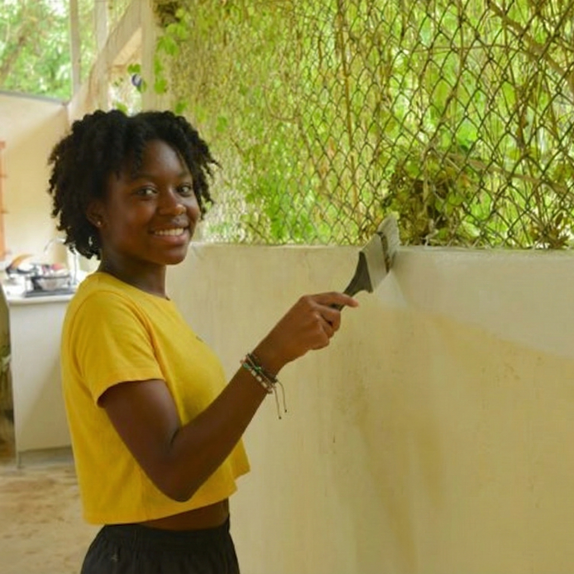 Volunteer actively painting a wall